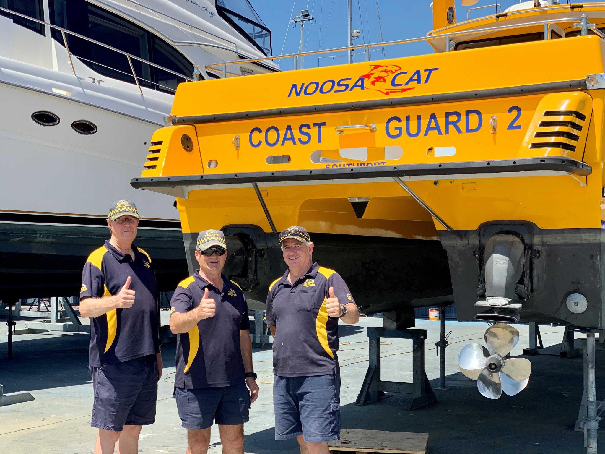 Craig Mills, Commander Mike Hoffman, Danny Nugent GC Coast Guard Southport November 2019 The Boat Works