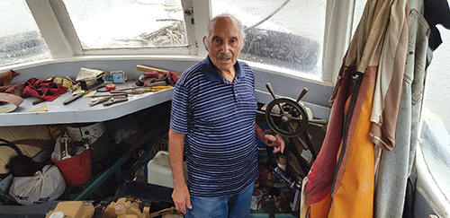 Frank Illacqua on his decommissioned fishing boat, one of only two left in Iron Cove